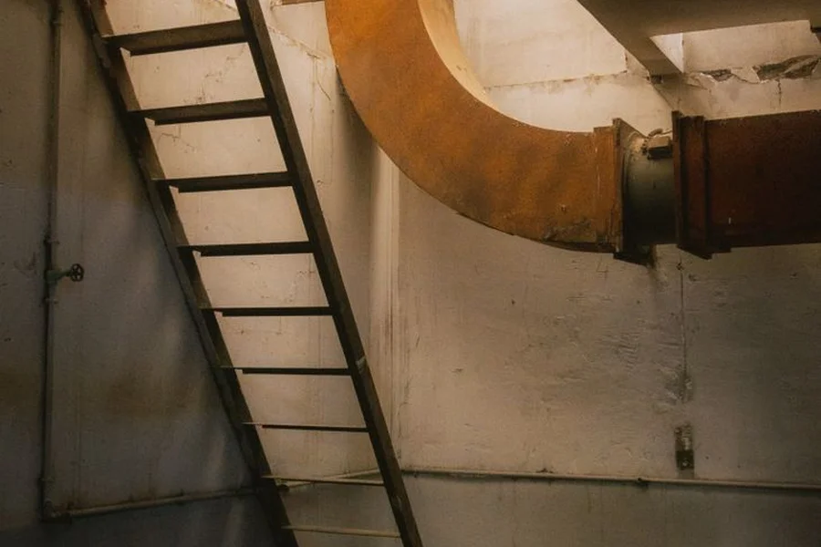 10 Cloverfield Lane Review: Suspense, Cast, and Franchise Ties Dimly lit underground concrete basement room