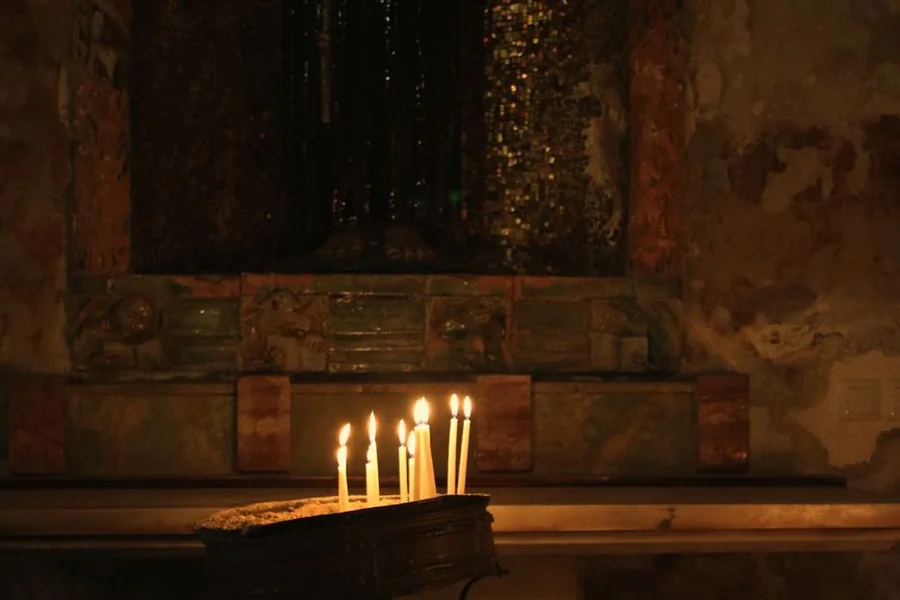 Jesus in Orthodox Christianity: Christology, Icons, and Theosis Ancient stone church altar glowing with warm candlelight