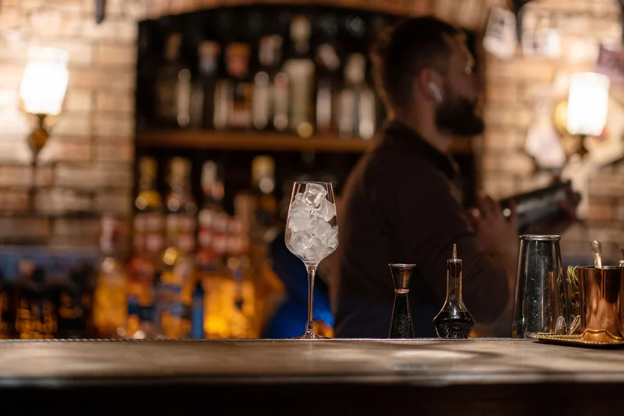 Best Speakeasy Bars in Cleveland: Secret Doors and Cocktails Artisanal cocktail in vintage glassware on a dark wooden bar counter