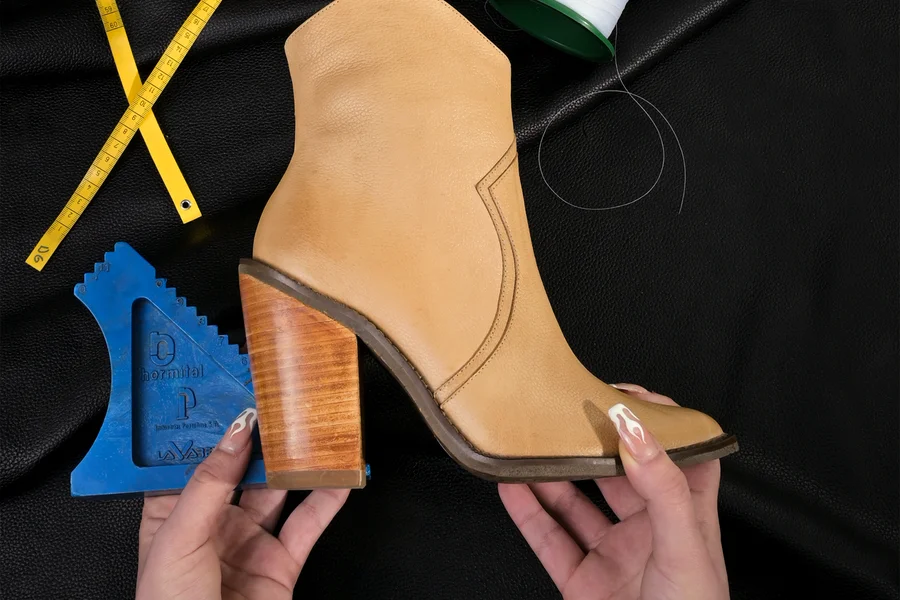 Tyrolean Shoes Guide: History, Construction, and Styling Tips Artisan shoemaker stitching leather upper on a workbench