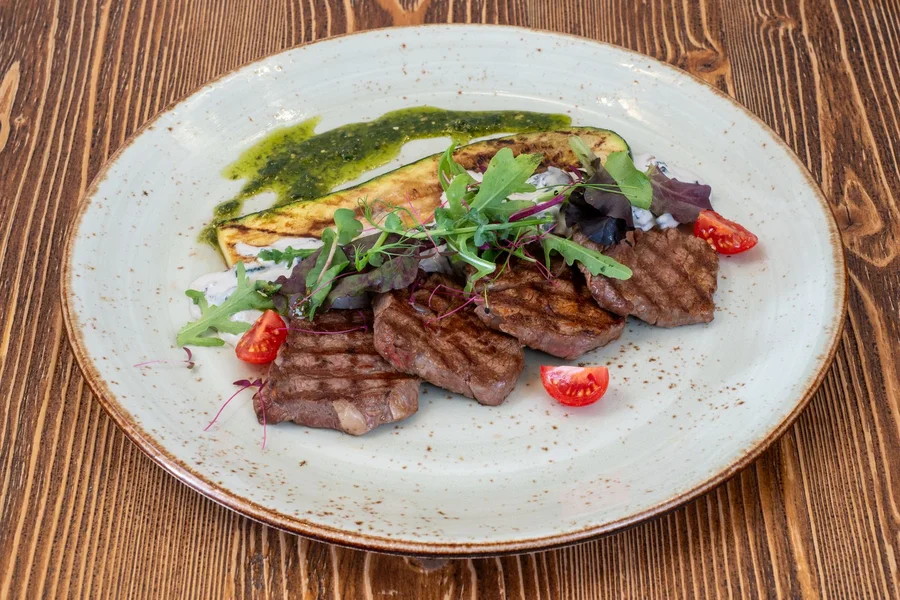 Rocket Chef Turbo Grill Review: Does This Microwave Grill Actually Work? Grilled steak and fresh vegetables cooked on a Rocket Chef Turbo Grill plate